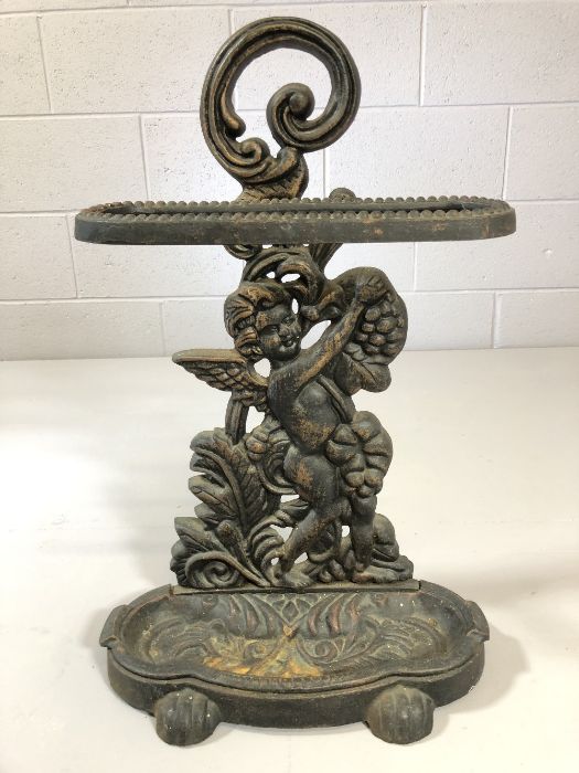 Wrought iron stick / umbrella stand depicting a winged cherub, approx 60cm tall
