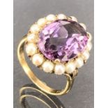 9ct Gold ring set with a large faceted Amethyst stone approx 16mm x 12mm and surrounded by seed