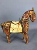 Tang Style carved wooden horse with brass detailing to ears, tail and saddle, the saddle with bone