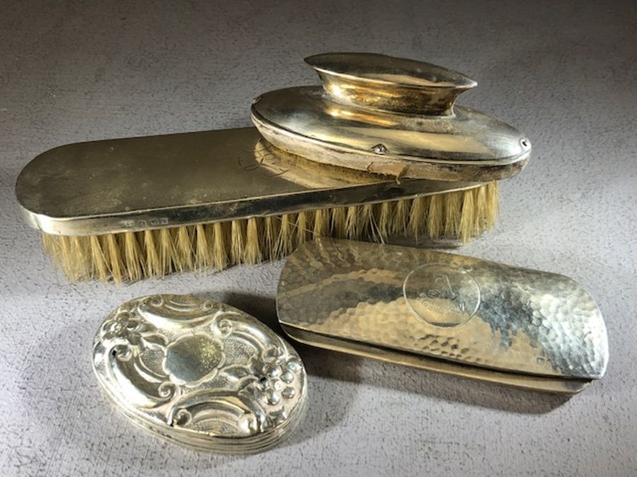 Collection of hallmarked silver items to include a clothes brush, hammered glasses case, nail file