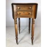 Drop leaf side table on turned legs with brass castors, two drawers and two faux drawers, approx