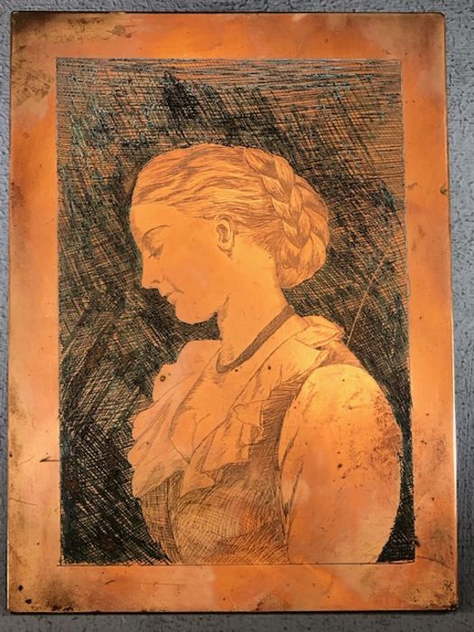 Brass plaque depicting the portrait of a lady possibly for brass rubbings