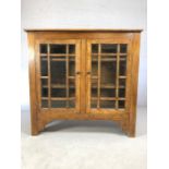 Oak two door bookcase with two shelves and two keys and glass fronted doors, approx 35cm x 103cm x