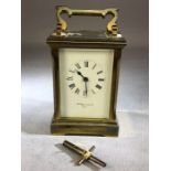 Carriage clock, with white enamel dial and Roman numerals, visible escapement and the rear plate