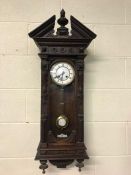 Wooden cased Vienna wall clock with pendulum and key, approx 94cm in height
