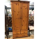 Pine two door wardrobe with two drawers under, approx 85cm x 52cm x 180cm tall