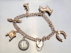 Silver Charm Bracelet with silver chinese token, and silver heart shaped lock