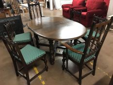 Ercol extending dining room table and six spindle back chairs (two carvers)