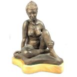 Bronze style sculpture of a naked seated lady on wooden base approx 29cm tall