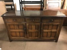 Dark oak linen fold sideboard with three drawers and three cupboards, approx 152cm x 46cm x 87cm