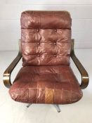 Mid Century easy chair on chrome base with crimson leather button back seat