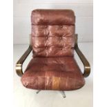 Mid Century easy chair on chrome base with crimson leather button back seat