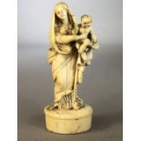 Intricate carving of the Madonna and Child carved from Bone with fine detail approx 9cm tall