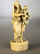 Intricate carving of the Madonna and Child carved from Bone with fine detail approx 9cm tall