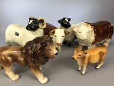 Five pieces of Cooperware to include bull (slight crack to foot) and cow, ram and sheep, a lion plus