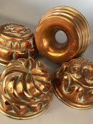 Collection of four copper jelly moulds of varying designs