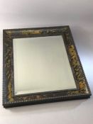 Ercol: tortoiseshell wall mirror, with ebonized ripple mouldings and a bevelled rectangular plate,