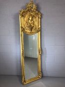 Large gilt framed, bevel edged mirror with relief figure of a lady, approx height 177cm x 52cm wide