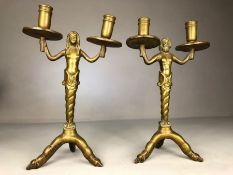 Pair of solid heavy brass double candlestickes male and female emerging from a twisted sea shell