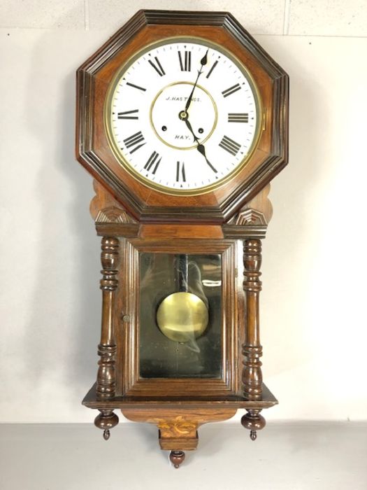 8 day spring-driven American wall clock by Waterbury Clock Co, English walnut case with floral inlay