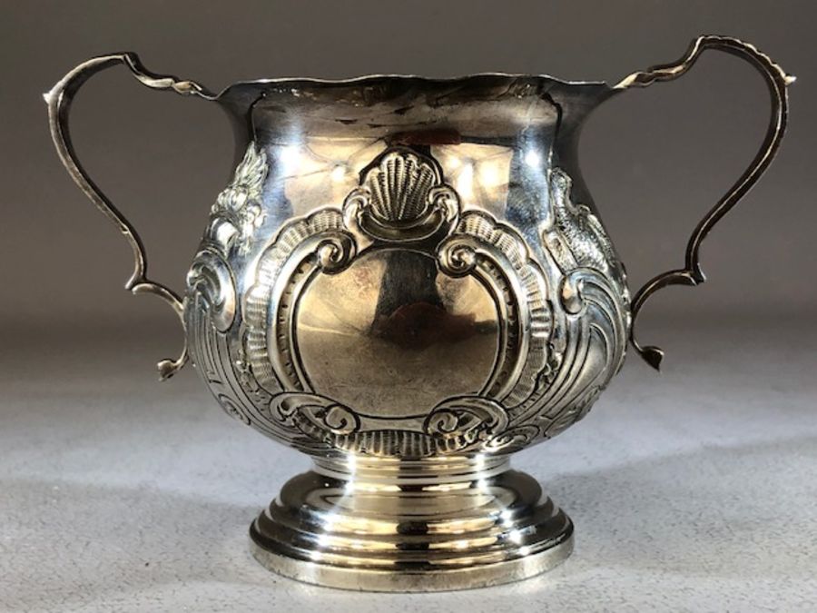 Silver hallmarked loving cup with two repousse design on a stepped base Birmingham Walker & Hall