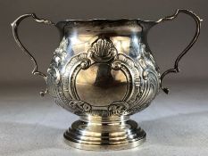 Silver hallmarked loving cup with two repousse design on a stepped base Birmingham Walker & Hall