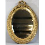 Oval Regency-style gilt framed bevel edged mirror with floral and beaded design, overall height