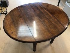 Drop leaf oak dining room table on reed and turned legs, approx 113cm wide, with eight upholstered