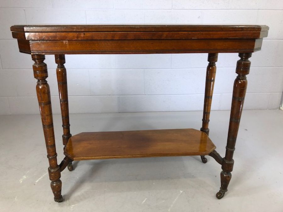 Two tier card table with green baize on turned legs with original castors, approx 87cm x 43cm x 73cm