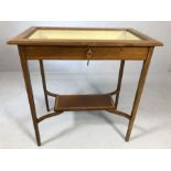 Edwardian inlaid silver table with bevelled glass, yellow silk lining, shelf below and key, approx