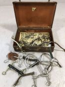 Equestrian interest; Collection of riding bits and stirrups in vintage case