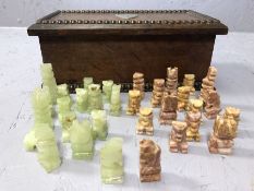 Carved wooden box containing a soap stone chess set