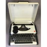 Vintage Olympia Traveller typewriter with travel case, original box and paperwork including