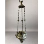 Bronze hanging incense burner decorated with three lion's heads, supported by chains, approx 29cm in