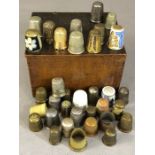 Collection of circa 36 thimbles, in a variety of materials, of varying ages and designs, in wooden