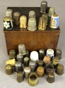 Collection of circa 36 thimbles, in a variety of materials, of varying ages and designs, in wooden