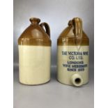 Two vintage cider flagons, one marked 'THE VICTORIA WINE CO. LTD. LONDON'S WINE MERCHANTS SINCE