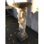 Stone birdbath supported by a figure of a child, approx 87cm in height