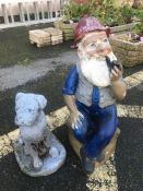 Two garden ornaments: a dog and a smoking man