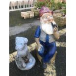 Two garden ornaments: a dog and a smoking man