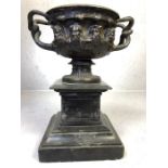 19th Century Roman style bronze two handled vase on polished slate base with cast heads and fluted