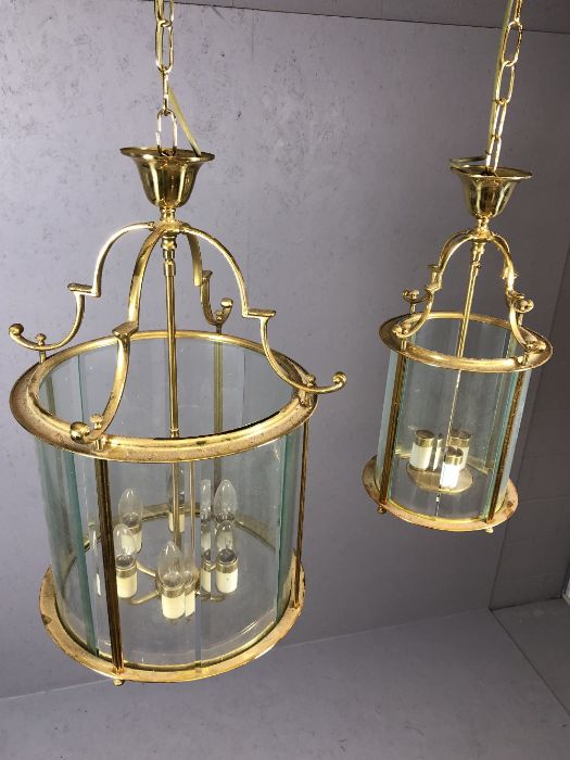 Two brass pendant lights with round glass shades, the larger approx 65cm in drop - Image 3 of 5