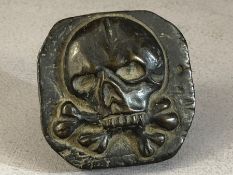 Small bronze weight with scull motif, approx 16cm x 16cm