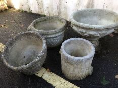 Collection of four stone garden planters of varying deign