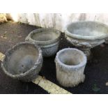 Collection of four stone garden planters of varying deign