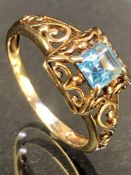 9ct Gold ring set with a Blue Topaz approx 5mm square in ornate pierced setting size 'P'