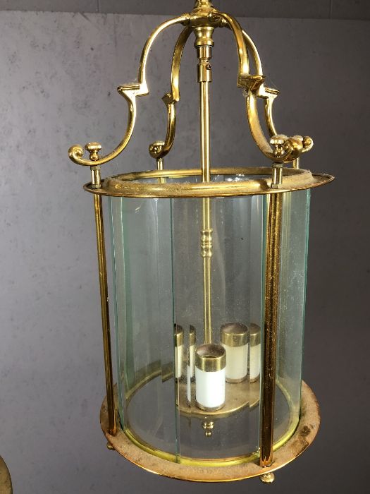 Two brass pendant lights with round glass shades, the larger approx 65cm in drop - Image 4 of 5