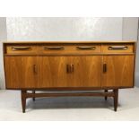 G-Plan Mid Century sideboard with three cupboards and three drawers under on tapered legs. Approx