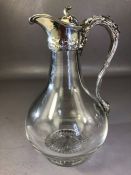 Military interest: Glass and hallmarked Silver Claret Jug with foliate design and engraved lid for