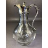 Military interest: Glass and hallmarked Silver Claret Jug with foliate design and engraved lid for